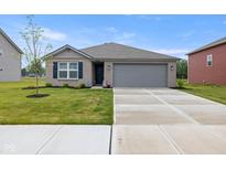 Charming single-story home with a well-manicured lawn and a spacious two-car garage at 24416 Kercheval St, Sheridan, IN 46069