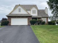 Charming two-story home boasts a well-maintained lawn, brick accents, and an attached two-car garage at 2925 Morgan Trl, Martinsville, IN 46151