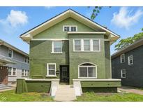 Charming two-story home with a green exterior, white trim, and well-maintained lawn on a sunny day at 3307 N College Ave, Indianapolis, IN 46205