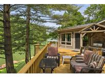 A beautiful back deck overlooking the lake complete with seating and an outdoor cooking space at 4126 E Rembrandt Dr, Martinsville, IN 46151