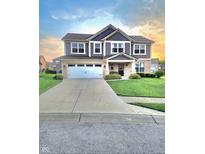 Charming two-story home featuring a two-car garage, landscaped yard, and inviting front porch at 4216 Lauder Rd, Bargersville, IN 46106