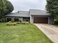 Charming home featuring a well-manicured lawn and an attached two-car garage at 4760 Winterberry Pl, Columbus, IN 47201