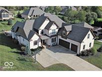 Stunning two-story home boasts a brick facade, three-car garage, and a spacious driveway with a basketball hoop at 4931 Kerrington Blvd, Bargersville, IN 46106