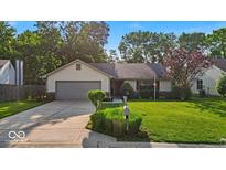 Charming ranch-style home featuring a well-manicured lawn and an attached two-car garage at 5010 Donner Ln, Indianapolis, IN 46268