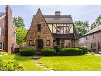 Charming Tudor-style home with brick facade, gabled roof, and well-manicured lawn and shrubbery at 5615 N Pennsylvania St, Indianapolis, IN 46220