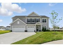 Beautiful two-story home featuring a three-car garage and well-manicured lawn in a suburban neighborhood at 5763 Greenbrier Ct, Brownsburg, IN 46112