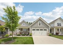 Charming single-story home featuring a well-manicured lawn, a two-car garage, and pleasing architectural details at 624 Faudree Dr, Westfield, IN 46074