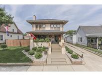 Charming two-story home featuring landscaped yard and inviting front porch at 629 S Miller St, Shelbyville, IN 46176
