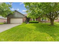 Charming single-story brick home featuring an attached two-car garage and a well-maintained lawn at 6629 Woodcrest Dr, Avon, IN 46123