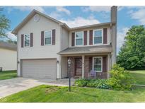 Charming two-story home with brick front porch and well-manicured lawn in a desirable neighborhood at 6635 Blackthorn Dr, Indianapolis, IN 46221