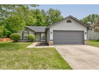 Charming single Gathering home featuring a two-car garage, and well-maintained landscaping at 7239 Wet Rock Ct, Indianapolis, IN 46236