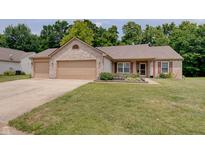 Charming brick home featuring a three-car garage and a well-manicured front lawn at 7372 Oakview Dr, Avon, IN 46123