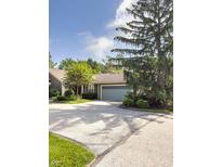 Charming home featuring a light blue garage door and a tree in the front yard at 7470 Charrington Ct, Indianapolis, IN 46254