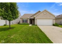 Charming single-story home featuring a well-manicured lawn and attached two-car garage at 7715 Bolero Dr, Camby, IN 46113