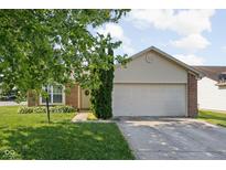 Charming single-story home featuring a two-car garage, front yard and brick accents at 779 Alvey Ct, Greenwood, IN 46143
