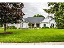 Charming brick home with a lush green lawn and mature trees, providing great curb appeal at 9678 Winter Way, Zionsville, IN 46077