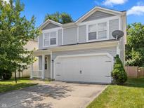 Charming two-story home with a two car garage and landscaped front yard in a residential community at 10427 Apple Creek Dr, Indianapolis, IN 46235