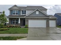 Charming two-story home with a two-car garage, brick accents, and a well-manicured lawn at 1439 Silver Pine Ln, Sheridan, IN 46069