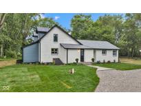 Charming two-story home with freshly painted white brick, professional landscaping, and gravel driveway at 1805 Center Valley Rd, Martinsville, IN 46151