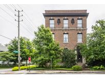 Brick building featuring symmetrical windows, decorative stone accents and mature trees at 3959 Central Ave, Indianapolis, IN 46205
