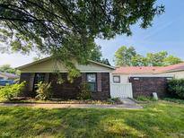 Charming single-story home with a brick facade and a well-maintained lawn with healthy green grass at 4408 Clovelly Ct, Indianapolis, IN 46254