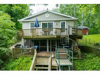 Charming home with a multilevel wooden deck, spiral staircase and mature trees at 460 W Hinshaw Dr, Nineveh, IN 46164