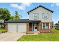 Charming two-story home with a two-car garage and well-manicured lawn at 4749 Rocky Knob Ln, Indianapolis, IN 46254