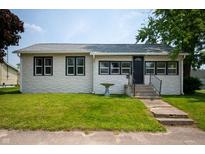 Charming single-story home featuring a well-maintained lawn, bird bath, and neutral exterior at 517 N Leland St, Fortville, IN 46040