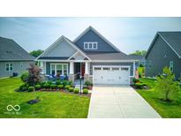 Charming single-Gathering home with a well-manicured lawn, attached garage, and inviting front porch at 5199 Green Valley Ln, Noblesville, IN 46062