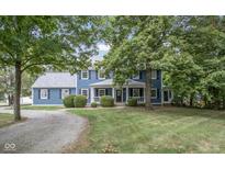 Charming two-story home with a well-manicured front yard and mature trees providing shade and curb appeal at 5538 N 700 W, McCordsville, IN 46055