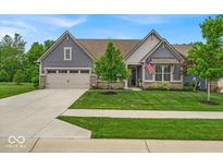 Beautifully landscaped front yard with lush green grass leading up to a modern blue home at 6536 Apperson Dr, Noblesville, IN 46060