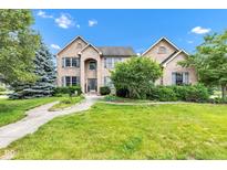 Traditional two-story brick home with a well-manicured lawn and mature trees at 705 Ridge Gate Dr, Brownsburg, IN 46112