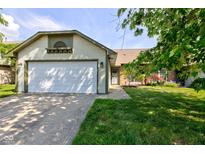 Charming single-story home featuring a well-maintained lawn and an attached two-car garage at 7150 Eagle Cove Dr, Indianapolis, IN 46254