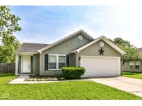 Charming single-story home with a well-manicured lawn and two car garage, perfect for suburban living at 7639 Foxglove Ln, Noblesville, IN 46062
