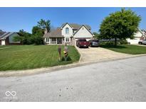 Charming two-story home with a well-manicured lawn, mature tree and convenient driveway parking at 902 St Andrews Dr, Avon, IN 46123