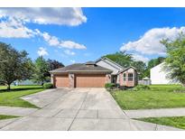 Charming two-story home with a well-maintained front yard, three-car garage, and inviting curb appeal at 9055 Glass Chimney Ln, Fishers, IN 46037