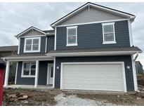New construction two-story home featuring a large white garage door, a blue facade, and white window trim at 9125 Steinbeck Ln, Indianapolis, IN 46239