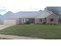Charming single-story brick home featuring an attached two-car garage and a well-maintained front yard at 920 Corey Ln, Plainfield, IN 46168