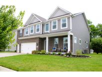 Charming two-story home with brick and gray siding, covered porch, and well-manicured lawn at 10113 Gallop Ln, Fishers, IN 46040