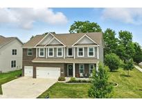 Charming two-story home with a well-manicured lawn and attached two-car garage in a lovely neighborhood at 10113 Gallop Ln, Fishers, IN 46040