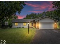 Charming ranch home featuring a well-manicured lawn, attached two car garage, and inviting curb appeal at 110 Leichester Ct, Noblesville, IN 46060