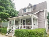 Charming home featuring a welcoming front porch and well-maintained landscaping at 121 N Main St, Pendleton, IN 46064