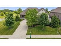 Lovely traditional style home with manicured lawn, mature trees, and a long driveway at 16548 Grand Cypress Dr, Noblesville, IN 46060