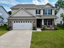 Beautiful two-story home with a brick and siding exterior, a two car garage, and well-manicured lawn at 16551 Branham Dr, Fishers, IN 46040