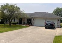Charming brick ranch home with a well-maintained front yard and attached two-car garage at 2213 Holden Dr, Anderson, IN 46012
