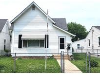 Charming white single Gathering home with a well-maintained lawn and an inviting front entrance at 408 W 4Th St, Anderson, IN 46016