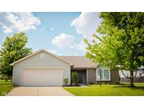Charming single-story home featuring a two-car garage, brick facade, and well-manicured lawn at 4114 Dunedin Ct, Noblesville, IN 46062