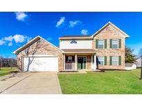 Charming two-story brick home with a well-maintained lawn and attached two-car garage at 413 Youngs Creek Ct, Franklin, IN 46131