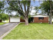 Charming brick home with an attached garage and a well-maintained front yard at 5667 Broyles Rd, Avon, IN 46123