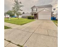 Charming two-story home featuring a well-manicured lawn and a spacious two-car garage at 5924 Sable Dr, Indianapolis, IN 46221